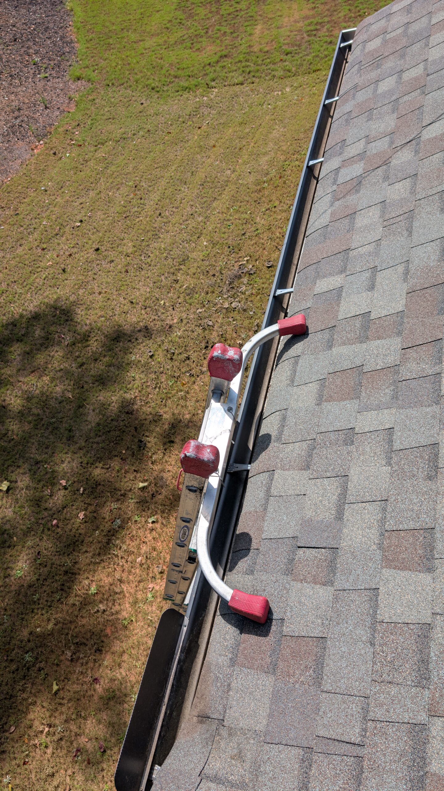 Clean residential home exterior with sparkling gutters