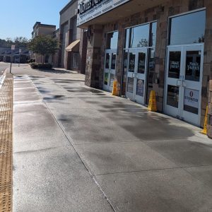 Wet sidewalk outside a shopping center