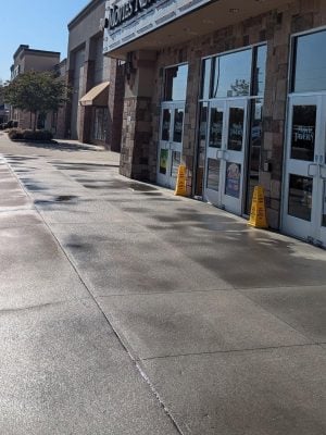 Wet sidewalk outside a shopping center