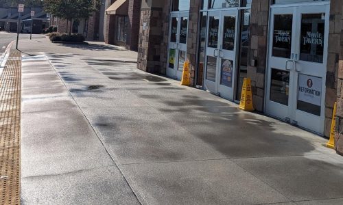 Wet sidewalk outside a shopping center