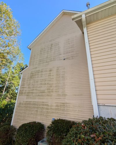 Dirty house siding with clear sky